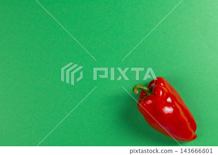 Red pepper resting on a green background Red pepper resting on a green background 143666801