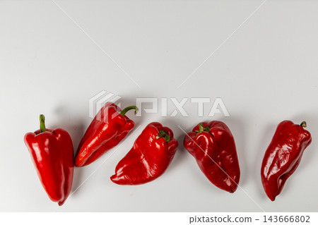 Red peppers arranged on a white background for food preparation Red peppers arranged on a white background for food preparation 143666802