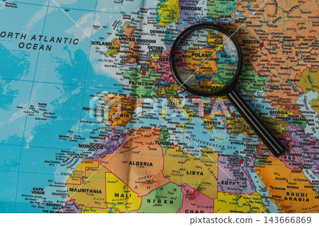 Exploration of Europe with a magnifying glass on a world map Exploration of Europe with a magnifying glass on a world map 143666869