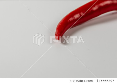 Red chili pepper on a white surface for cooking Red chili pepper on a white surface for cooking 143666897