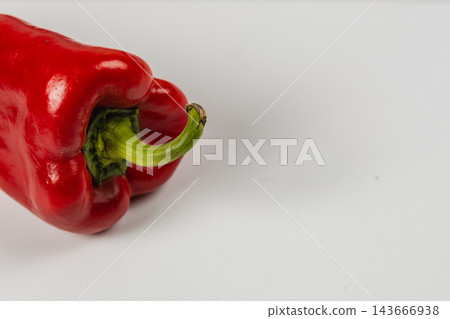 Red pepper with stem on a white background Red pepper with stem on a white background 143666938