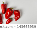 Red peppers arranged on a white background for cooking 143666939