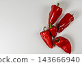 Red sweet peppers arranged on a white background 143666940