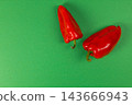 Red sweet peppers arranged on a green background for cooking 143666943