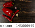 Peppers, chili and garlic arranged on a wood table 143666945