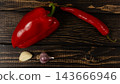 Pepper, chili, onion, and garlic on a wooden surface 143666946