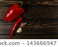 Red pepper, chili, onion, and garlic on a wooden table 143666947