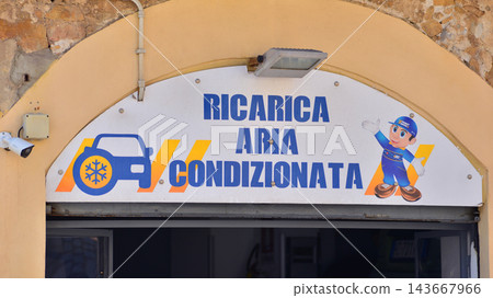 Cefalu, Italy. 21 August 2026. Urban landscape. Sign with the inscription: Ricarica Aria Condizionata. 143667966