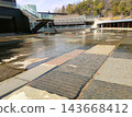 A modern cobblestone patio with flowing water. 143668412