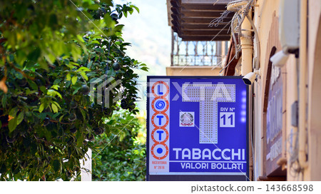 Cefalu, Italy. 21 August 2026. Urban landscape. Neon sign with the inscription: Tabacchi Valori Bollati. 143668598