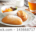 Lunch consisted of homemade cream buns, pain au lait, and scones. 143668717