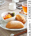 Lunch consisted of homemade cream buns, pain au lait, and scones. 143668718