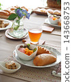 Lunch consisted of homemade cream buns, pain au lait, and scones. 143668753