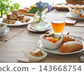 Lunch consisted of homemade cream buns, pain au lait, and scones. 143668754
