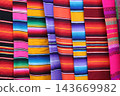 Colorful mexican serapes displaying traditional woven striped fabric 143669982
