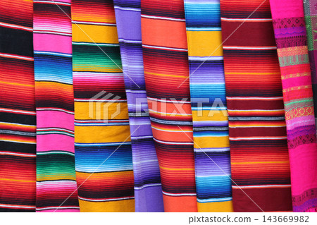 Colorful mexican serapes displaying traditional woven striped fabric 143669982
