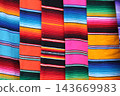 Colorful mexican serape blankets displaying vibrant striped textile pattern 143669983