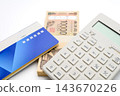 A calculator, a bankbook, and a 10,000 yen bill. 143670226