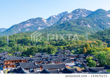 Traditional Korean Hanok Houses and Tiled Roofs against Bukhansan Mountain in Eunpyeong Hanok Village, Seoul Traditional Korean Hanok Houses and Tiled Roofs against Bukhansan Mountain in Eunpyeong Hanok Village, Seoul 143670255
