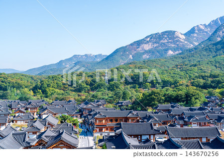 Traditional Korean Hanok Houses and Tiled Roofs against Bukhansan Mountain in Eunpyeong Hanok Village, Seoul Traditional Korean Hanok Houses and Tiled Roofs against Bukhansan Mountain in Eunpyeong Hanok Village, Seoul 143670256