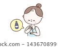 A woman uses a dropper to dispense serum into her palm and then applies it to her skin (skincare). 143670899
