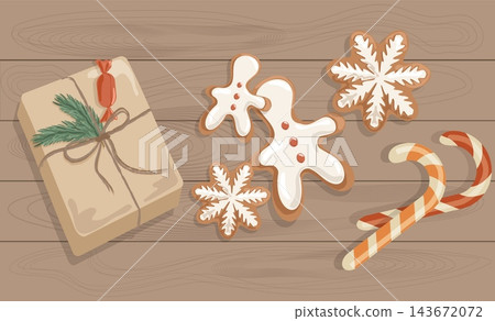 Flat lay Christmas gift box with gingerbread cookies and candy canes on wooden table. Cozy eco winter holiday sweets vector banner background Flat lay Christmas gift box with gingerbread cookies and candy canes on wooden table. Cozy eco winter holiday sweets vector banner background 143672072