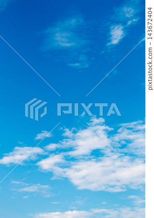 A refreshing vertical background image featuring white clouds and a blue gradient against a clear blue sky. A refreshing vertical background image featuring white clouds and a blue gradient against a clear blue sky. 143672404