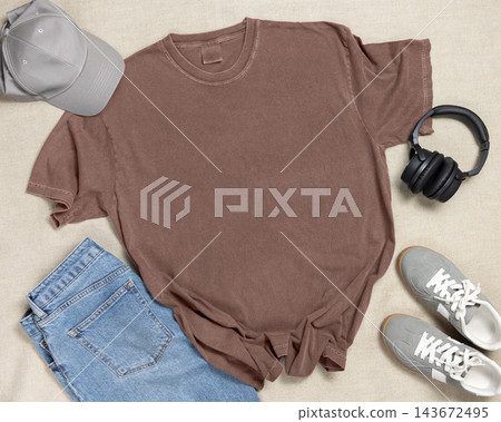 Blank washed brown unisex t-shirt mockup, crewneck flat lay with denim jeans and mens accessories 143672495