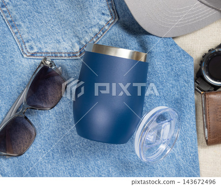 Blank dark blue 11oz tumbler mockup, travel thermos on denim near mens accessories, copy space Blank dark blue 11oz tumbler mockup, travel thermos on denim near mens accessories, copy space 143672496
