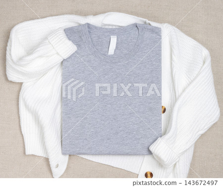 Heather grey folded t-shirt mockup on white knitted cardigan, template for print on demand 143672497