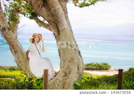 A woman in a white dress enjoying the nature of Okinawa 143673056