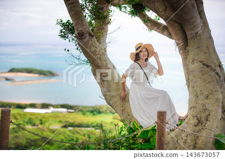 A woman in a white dress enjoying the nature of Okinawa A woman in a white dress enjoying the nature of Okinawa 143673057