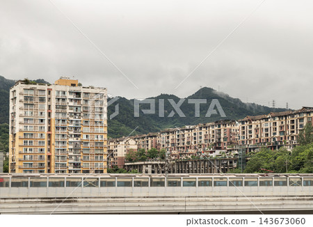 Chongqing Cityscape Framing Mountain Slopes and Modern Transit, Elevated Rail Line and Hillside Residential High-Rises in Chongqing Chongqing Cityscape Framing Mountain Slopes and Modern Transit, Elevated Rail Line and Hillside Residential High-Rises in Chongqing 143673060