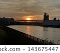 A river landscape illuminated by the setting sun. 143675447