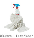 A spray bottle with a blue and red nozzle is partially covered by a crumpled white cloth. 143675887