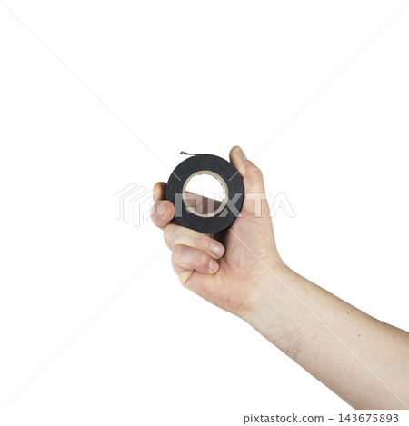 A hand holds a roll of black electrical tape A hand holds a roll of black electrical tape 143675893