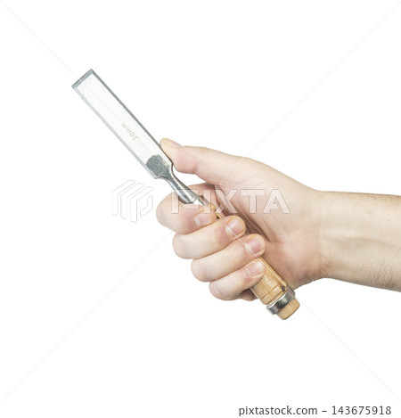 A hand holds a well-used metal putty knife with a wooden handle. A hand holds a well-used metal putty knife with a wooden handle. 143675918