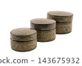 Three black, round, lidded boxes is decorated with intricate, colorful, traditional patterns. 143675932