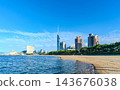 A view of Momochihama beach with a wide blue sky and Fukuoka Tower in the background. 143676038