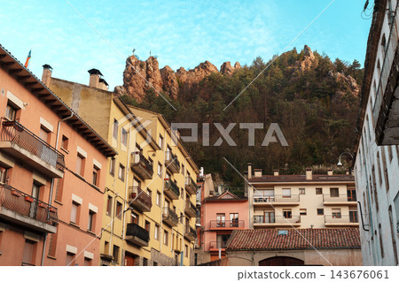 Rocky cliff above colorful balconied houses in Ribes de Fresser, Catalonia Rocky cliff above colorful balconied houses in Ribes de Fresser, Catalonia 143676061