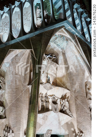 Crucifixion sculpture detail on the Passion facade of Sagrada Familia at night 143676230