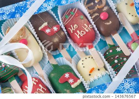Christmas dessert. Sweet food. Cheesecake stick ice cream. Treat in winter. Candy snowman, deer and Santa Claus. Gingerbread cookies Christmas dessert. Sweet food. Cheesecake stick ice cream. Treat in winter. Candy snowman, deer and Santa Claus. Gingerbread cookies 143676567