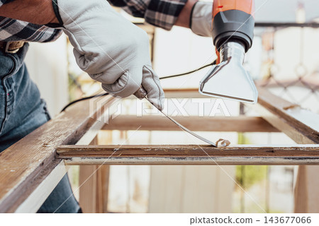 Carpenter at work, restoring an old wooden window. Carpentry. Carpenter at work, restoring an old wooden window. Carpentry. 143677066