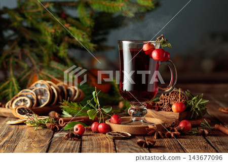 Mulled wine with crab apples and orange slices on an old wooden table. Mulled wine with crab apples and orange slices on an old wooden table. 143677096