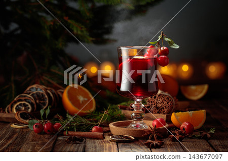 Mulled wine with crab apples and orange slices on an old wooden table. Mulled wine with crab apples and orange slices on an old wooden table. 143677097