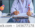 Medical worker checking biochemistry blood screening report on desk. 143677178