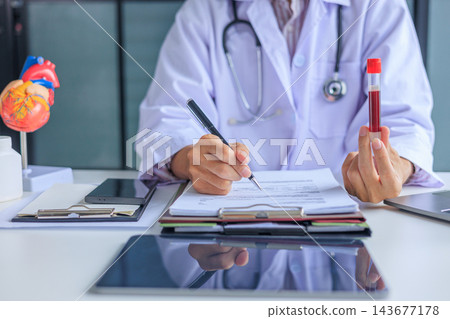Medical worker checking biochemistry blood screening report on desk. Medical worker checking biochemistry blood screening report on desk. 143677178