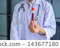 Healthcare professional holding blood sample tube. Hematology checkup and health assessment by medical specialist concept. 143677180
