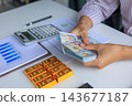 Banker, Accountant or Investor Counting Money with Gold Bars on the Table. Gold Commodity Trading and Market Analysis in Modern Office. 143677187