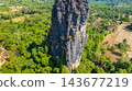Dramatic Limestone Peaks Over Verdant Countryside in Laos 143677219